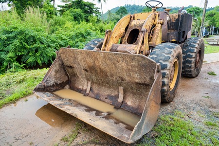 Trat, Thailand - May, 20, 2017 : Old rust vintage caterpillar tractor standing at Ao Thammachart Pier quay  on Trat Thailand.のeditorial素材