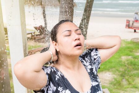 Trat, Thailand - May, 20, 2017 : Unidentified name woman showering outside near swimming pool after swimming in the sea at Klong Prao Resort in Prao Beach Koh Chang island Trat, Thailand.のeditorial素材