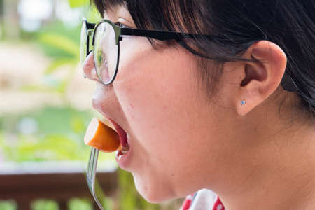 Trat, Thailand - May, 21, 2017 : Close up of a teen woman hands eating delicious breakfast with Scrambled eggs and Sausage at Klong Prao Resort in Koh Chang island Trat, Thailand.のeditorial素材