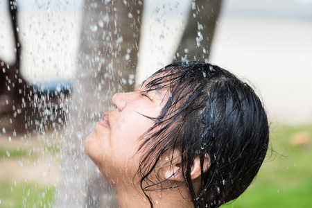 Trat, Thailand - May, 20, 2017 : Unidentified name teens woman showering outside near swimming pool after swimming in the sea at Klong Prao Resort in Prao Beach Koh Chang island Trat, Thailand.のeditorial素材