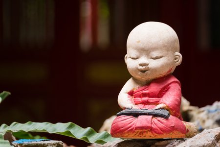 Closeup the Beautiful small statue of a novice in Wat Borom Raja Kanjanapisek Wat Leng Nei Yee 2 Temple, People go to temple to pray for good luck and success in life.のeditorial素材
