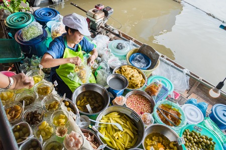 Bangkok, Thailand - June, 09, 2017 : Unidentified Woman sall Fruit picklet on a rowing boat in Taling Chan Floating Markett at Bangkok, Thailand.のeditorial素材