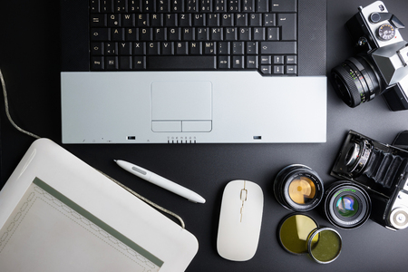Nonthaburi, Thailand - June, 28, 2017 : Top view of office stuff photographer with equipment analog ancient film camera, Laptop and wireless mouse.Concept analog photographer workplace.のeditorial素材