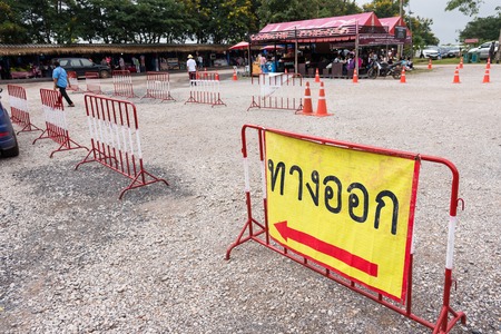 Chaiyaphum, Thailand - July, 01, 2017 : Exit sign with arrow,Directional signs with Thai text in the Pa Hin Ngam National Park go to the big green field of Siam Tulip at Chaiyaphum, Thailandのeditorial素材
