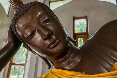 Nakhon Ratchasima, Thailand - July, 02, 2017 : Reclining sleeping golden buddha statue at temple in Nakhon Ratchasima, Thailandのeditorial素材