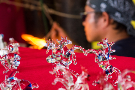 Phetchabun, Thailand - July, 15, 2017 : Handicrafts man making a glass animal with a flaming blowtorch on new glass art piece at Khao Kho Phetchabun Thailand.のeditorial素材