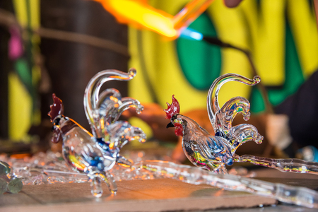 Phetchabun, Thailand - July, 15, 2017 : Chickens glass animal with a flaming blowtorch on new glass art piece at Khao Kho Phetchabun Thailand.のeditorial素材