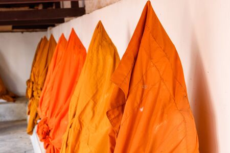 Ratchaburi, Thailand - July, 23, 2017 : The statue of golden Buddha is covered with orange robes in Wat Khanon at Ratchaburi, Thailandのeditorial素材