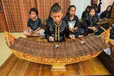 Ratchaburi, Thailand - July, 23, 2017 : Unidentified little boy plays the alto xylophone or Ranat in Thai classical ensemble which was traditionally played in Wat Khanon at Ratchaburi, Thailandのeditorial素材