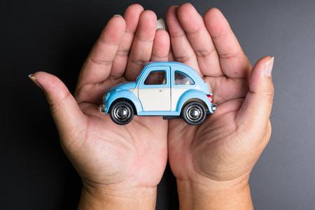 Nonthaburi, Thailand - September, 08, 2017 : Volkswagen Toy car in man hands on a black background. Concept of safe driving, Business concept.Nonthaburi, Thailandのeditorial素材