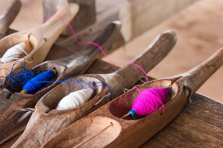 Colorful sewing thread in a wooden tubeの写真素材