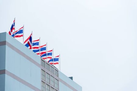 Flag of Thailand at the top of the buildingの写真素材