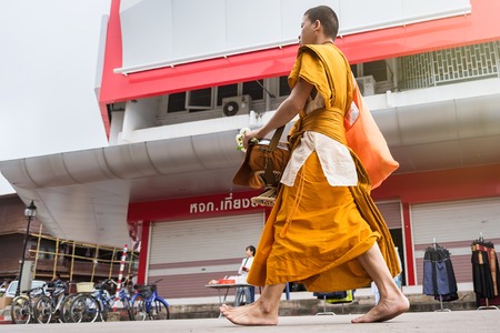 Nan, Thailand - September, 23, 2017 : Unidentified name buddhist monk was walking alms offering food to monks' alms-bowl in the morning market at Nan Province, Thailandのeditorial素材