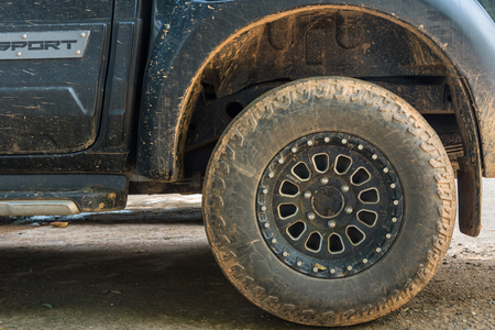 Nan, Thailand - September, 23, 2017 : Close up of tread tire 4x4 off road, Texture of dirty wheel pickup car. Adventure on countryside at Nan Province, Thailandのeditorial素材