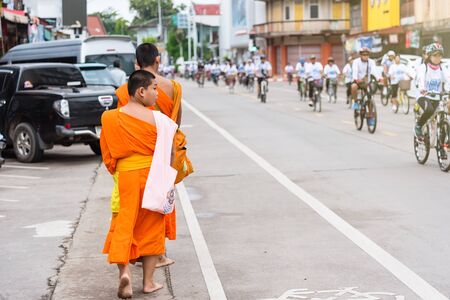 Nan, Thailand - September, 23, 2017 : Unidentified name buddhist monk alms offering food in the morning market at Nan Province, Thailandのeditorial素材
