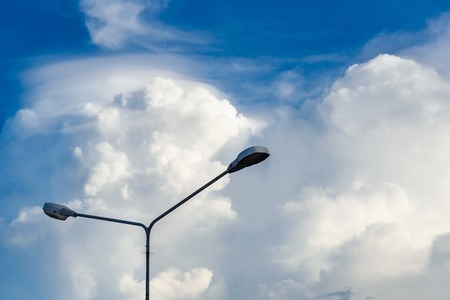 Electric street light pole on blue vivid sky in day lightの写真素材