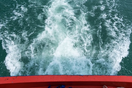 Sea wave of view behind the passenger boatの写真素材