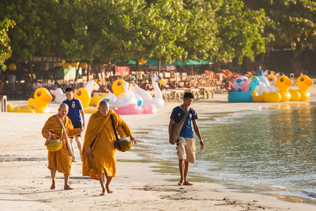 Rayong, Thailand - October, 08, 2017 : Unidentified name buddhist monk was walking alms offering food in the morning on the beach at the Koh Samet island, Rayong, Thailandのeditorial素材