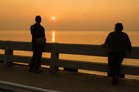 Samutprakan, Thailand - October, 29, 2017 : Unidentified name Tourists and visitors enjoy watching feeding and taking a photo of seagull birds on the bridge at Bangpoo in Samutprakan, Thailand.のeditorial素材