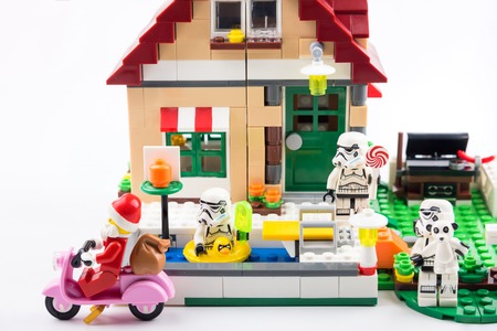 Nonthaburi, Thailand - November, 07, 2017 : Lego Santa Claus giving gifts to Lego star wars stormtrooper at front of the house in Christmas day.Theme Christmas day background.のeditorial素材