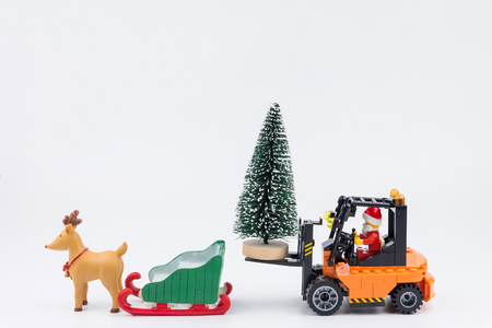 Nonthaburi, Thailand - November, 14, 2017 : Lego Santa Claus forklift driver transport christmas trees to snow sled at Christmas day.Theme Christmas day background.のeditorial素材