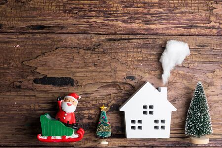 White wooden house toy and christmas decorations on wooden background with copy space.Christmas day conceptの写真素材
