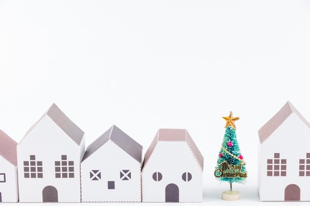 Christmas tree in the paper house town isolated on white background with copy space.Christmas day conceptの写真素材