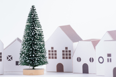 Christmas tree in the paper house town isolated on white background with copy space.Christmas day conceptの写真素材