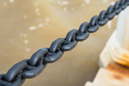 Chain secured to a handrail poleの写真素材