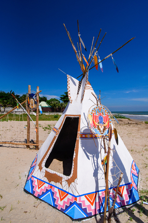 Native american indian tepee and totem pole on the beach blue sky day.Thailandの写真素材