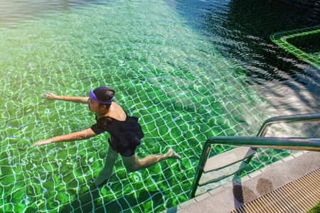 Prachuab Khirikhan, Thailand - November, 25, 2017 : Teenage girls are swimming in the hotel's rooftop pool of the hotel Hua Hin city at Prachuab Khirikhan, Thailand.のeditorial素材