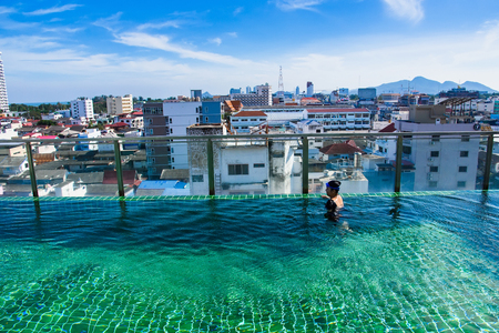 Prachuab Khirikhan, Thailand - November, 25, 2017 : Teenage girls are swimming in the hotel's rooftop pool of the hotel Hua Hin city at Prachuab Khirikhan, Thailand.のeditorial素材