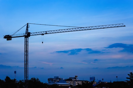 Building crane and construction site under sunset.Thailandの写真素材