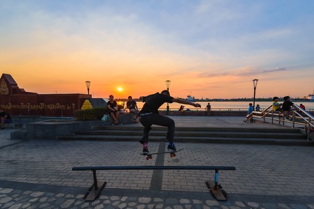 Samut Prakan, Thailand - December, 24, 2017 : Unidentified name man playing skateboard in park by the dam sunset time at Samut Prakan, Thailand.のeditorial素材