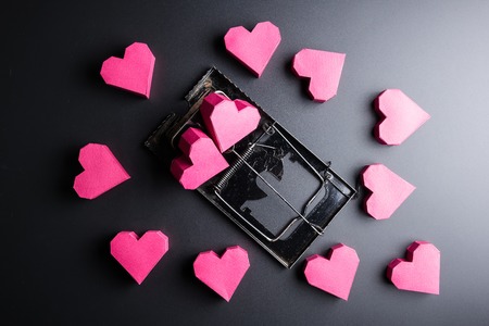 Mousetrap use box red heart shape as bait on black background with copy space.Valentine's Day, Day of loveの写真素材