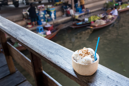 Coconut ice cream. Sweet coconut ice cream in the fresh coconut and plastic spoon.の写真素材