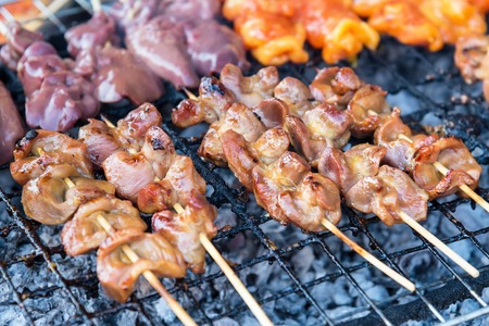 Chicken internal organs grill on charcoal stove at Sattahip market.Delicious local food.Street food of Thailandの写真素材