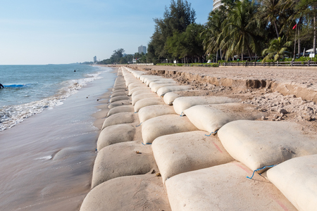 Line big sandbag prevent waves at Cha Am beach of Thailandの写真素材