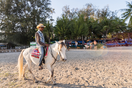 Prachuab Khirikhan, Thailand - December, 23, 2017 : Unidentified name people riding a horse at Khao Takiab beach of Thailand.のeditorial素材
