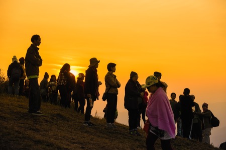 Phitsanulok, Thailand - January, 21, 2018 : Silhouette of Many tourist take to views sunrise and flower queen tiger at the Phu lom lo mountain in the morning on the weekend.のeditorial素材