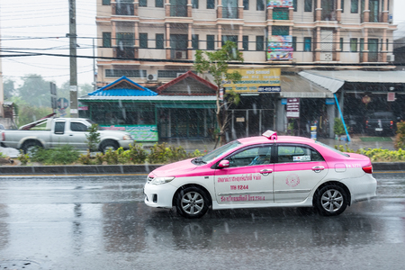 Nonthaburi, Thailand - February, 19, 2018 : Rainwater spraying from motion car wheels. city road during heavy rain at Nonthaburi, Thailand.のeditorial素材