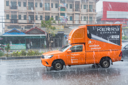 Nonthaburi, Thailand - February, 19, 2018 : Rainwater spraying from motion car wheels. city road during heavy rain at Nonthaburi, Thailand.のeditorial素材