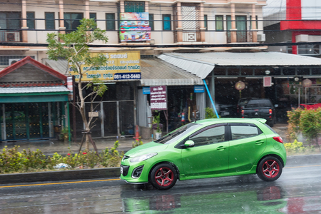 Nonthaburi, Thailand - February, 19, 2018 : Rainwater spraying from motion car wheels. city road during heavy rain at Nonthaburi, Thailand.のeditorial素材