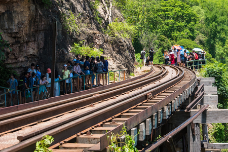 Kanchanaburii, Thailand - May, 13, 2018 : World war II historic railway, known as the Death Railway with a lot of tourists on the train taking photos of beautiful views at Kanchanaburii, Thailandのeditorial素材
