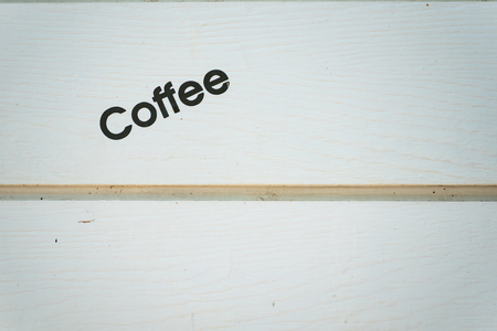 Picture of a coffee on a white wooden wallの写真素材