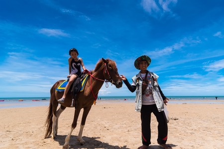 Prachuap Khiri Khan,Thailand - June, 03, 2018 : Unidentified name children wearing a swimsuit ride a horse at Hua Hin beach Prachuab Khirikhan, Thailandのeditorial素材
