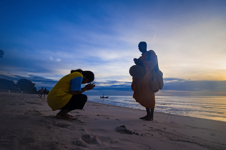 Prachuap Khiri Khan,Thailand - June, 03, 2018 : Unidentified name buddhist monk was walking alms offering food in the morning on the beach at Hua Hin Beach Prachuab Khirikhan, Thailand.のeditorial素材