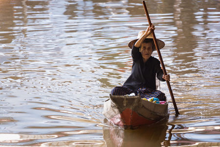 Ratchaburi,Thailand - June, 02, 2018 : Unidentified old woman vendor fruit floats in a boat at Damnoen Saduak floating market Ratchaburi, Thailand.のeditorial素材