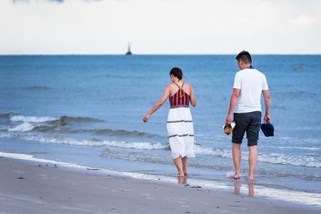 Prachuap Khiri Khan,Thailand - June, 02, 2018 : Unidentified name couple Chinese tourists walk on the beach in the evening sunset at Hua Hin Beach Prachuab Khirikhan, Thailand.のeditorial素材