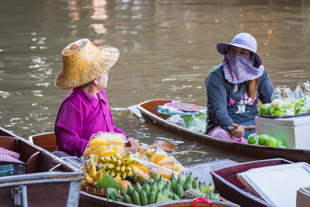 Ratchaburi,Thailand - June, 02, 2018 : Unidentified old woman vendor fruit floats in a boat at Damnoen Saduak floating market Ratchaburi, Thailand.のeditorial素材